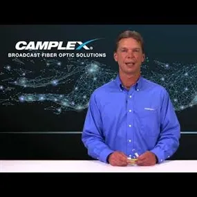 Man standing at Camplex Broadcast Fiber Optic Solutions desk presenting topic on Dual LC Fiber Polarity Swap Tip
